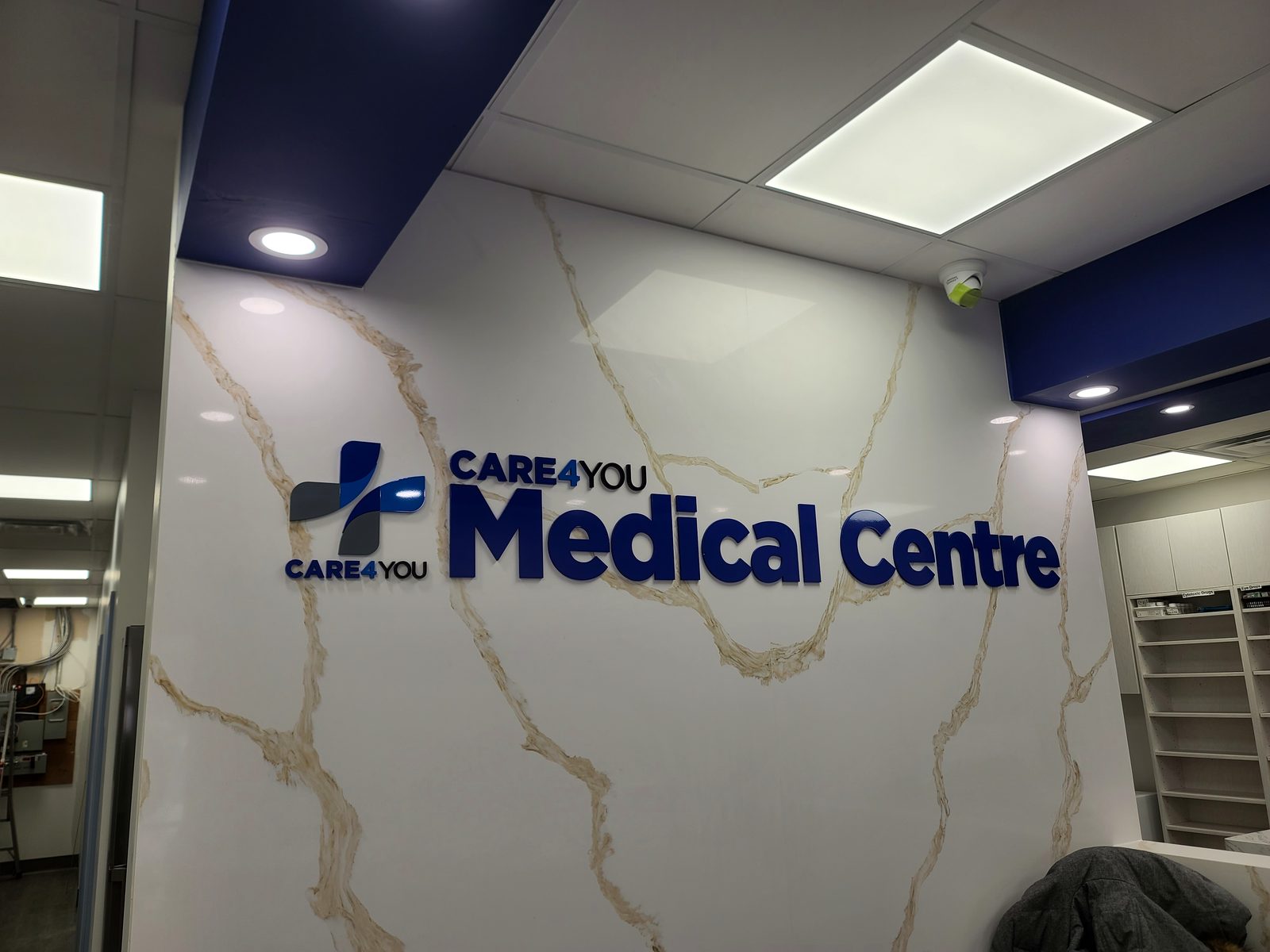 Dimensional signage on a quartz feature wall in a completed medical centre