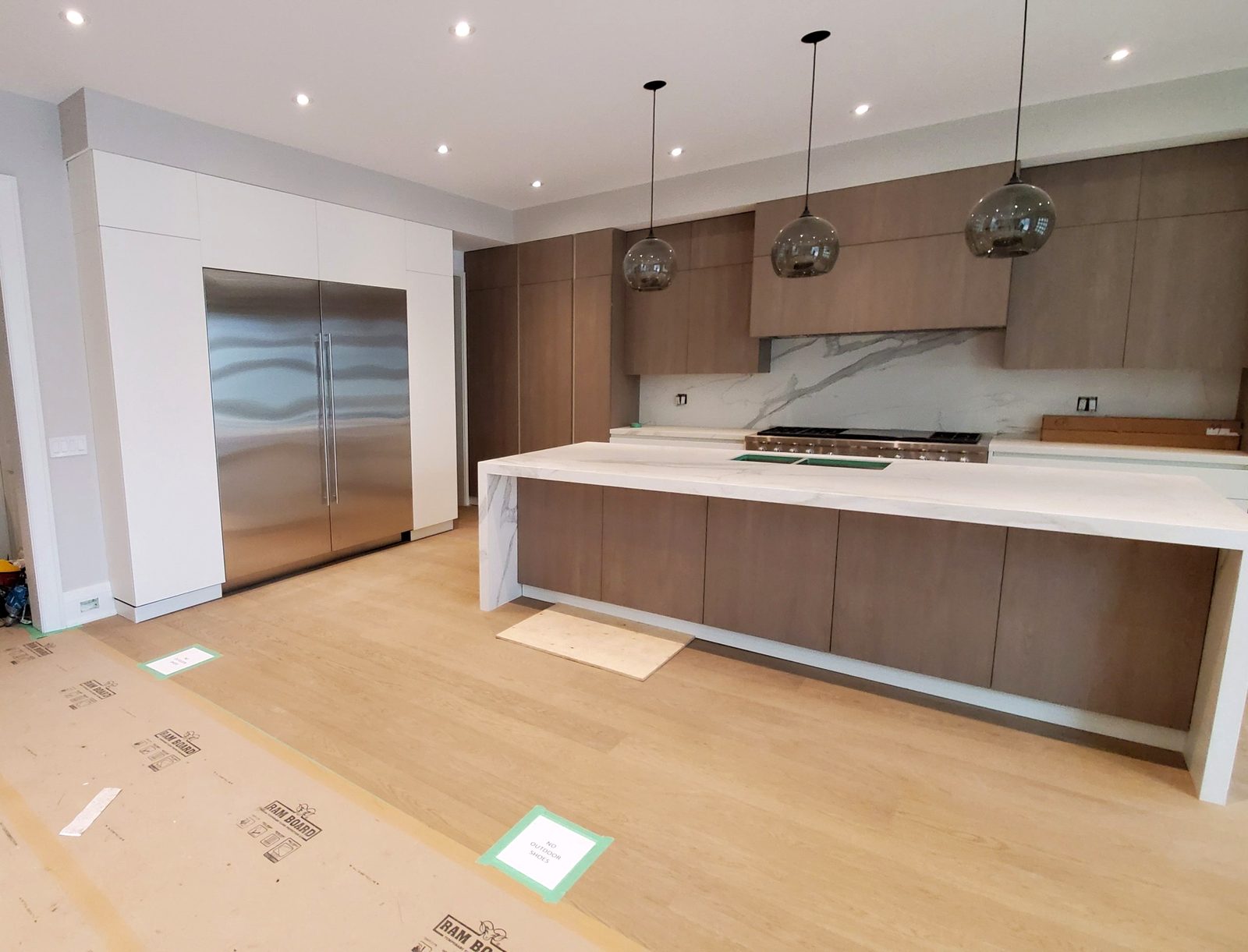 Modern chef's kitchen with waterfall island in a GTA home renovation