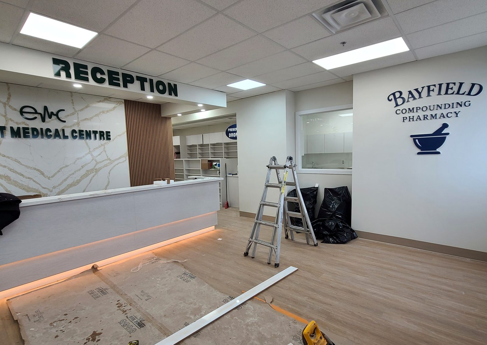 Medical centre reception desk with quartz feature wall nearing completion