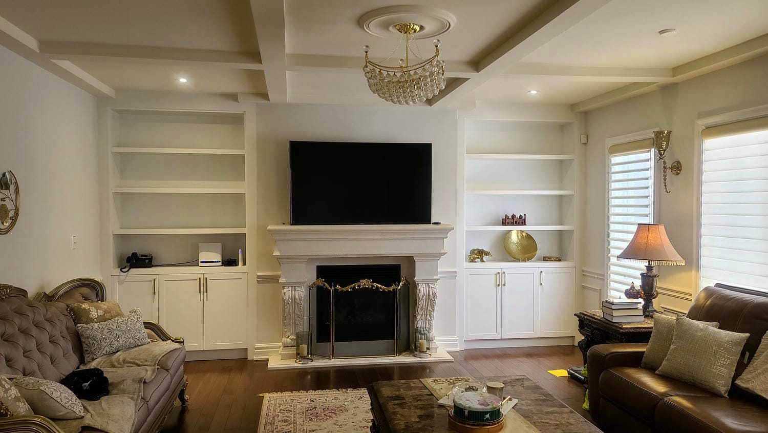 Fireplace with flanking built-in millwork and cabinetry
