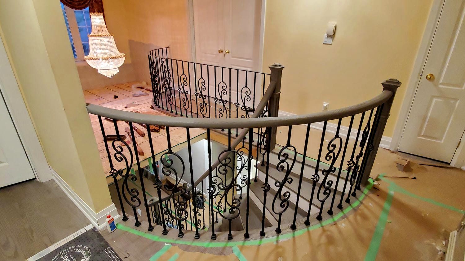 Curved staircase with wrought iron balustrade