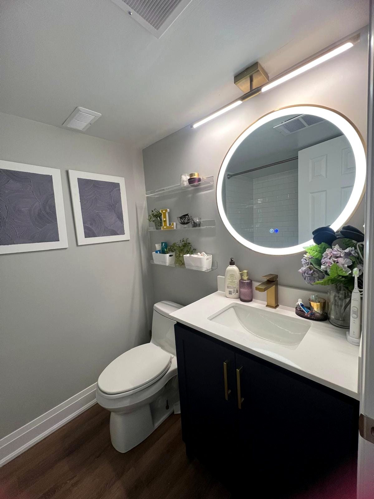 Renovated bathroom with backlit mirror