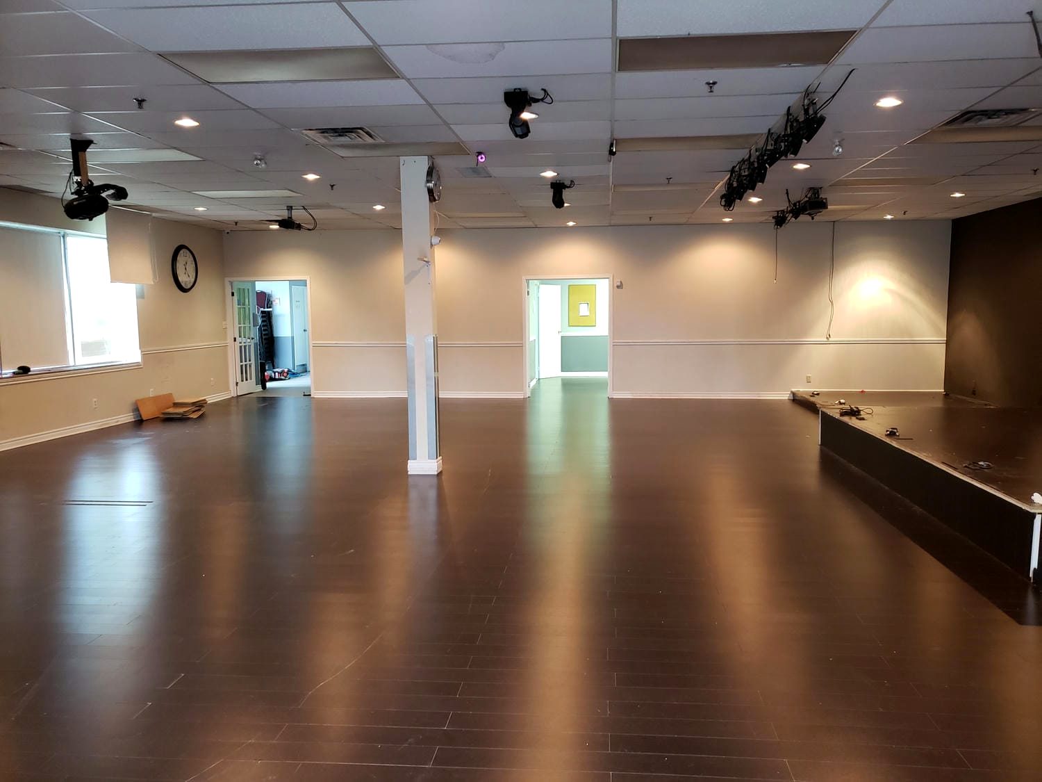 Finished commercial interior with dark hardwood floor and open ceiling