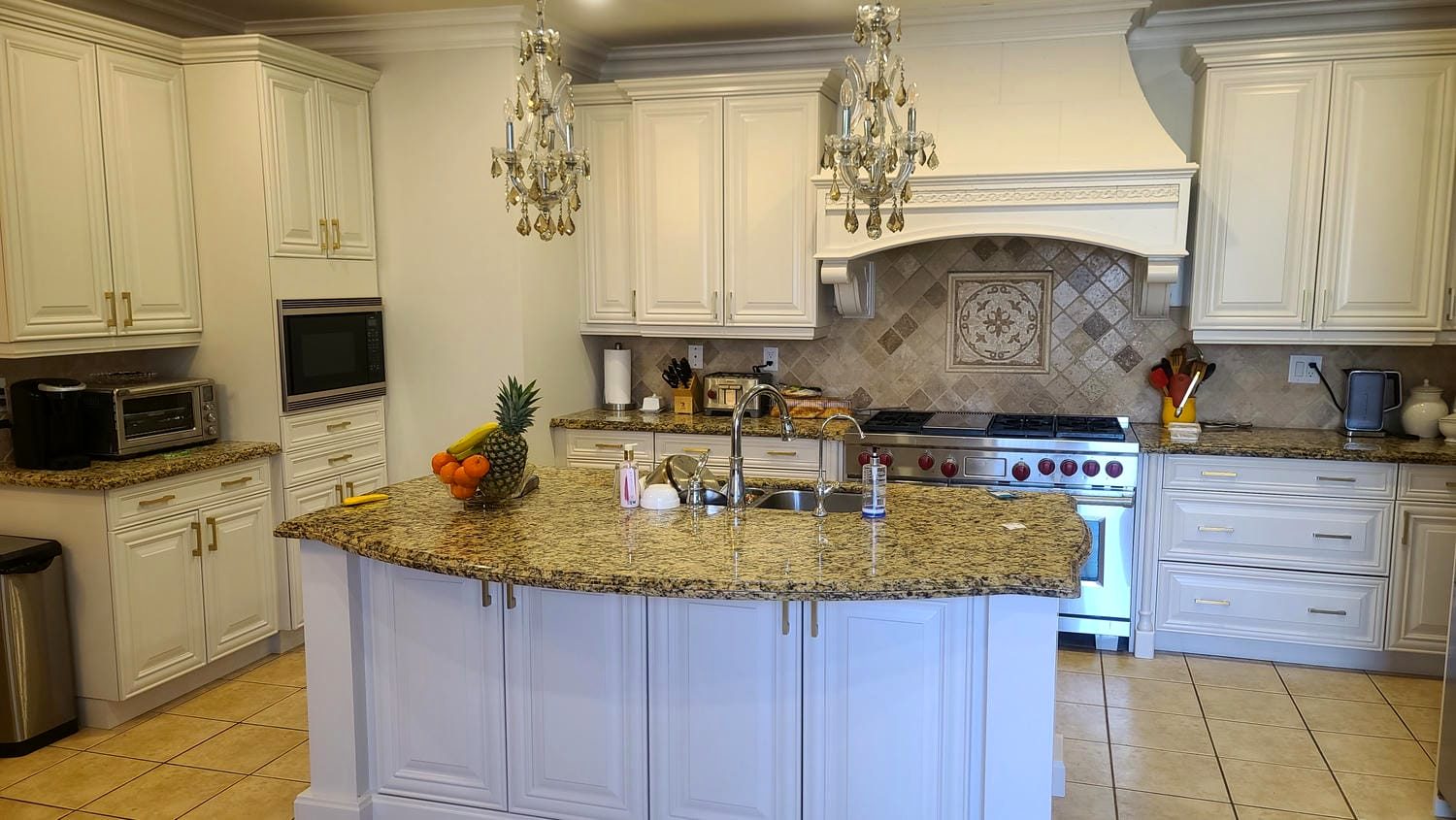 Traditional kitchen with granite counters and custom range hood